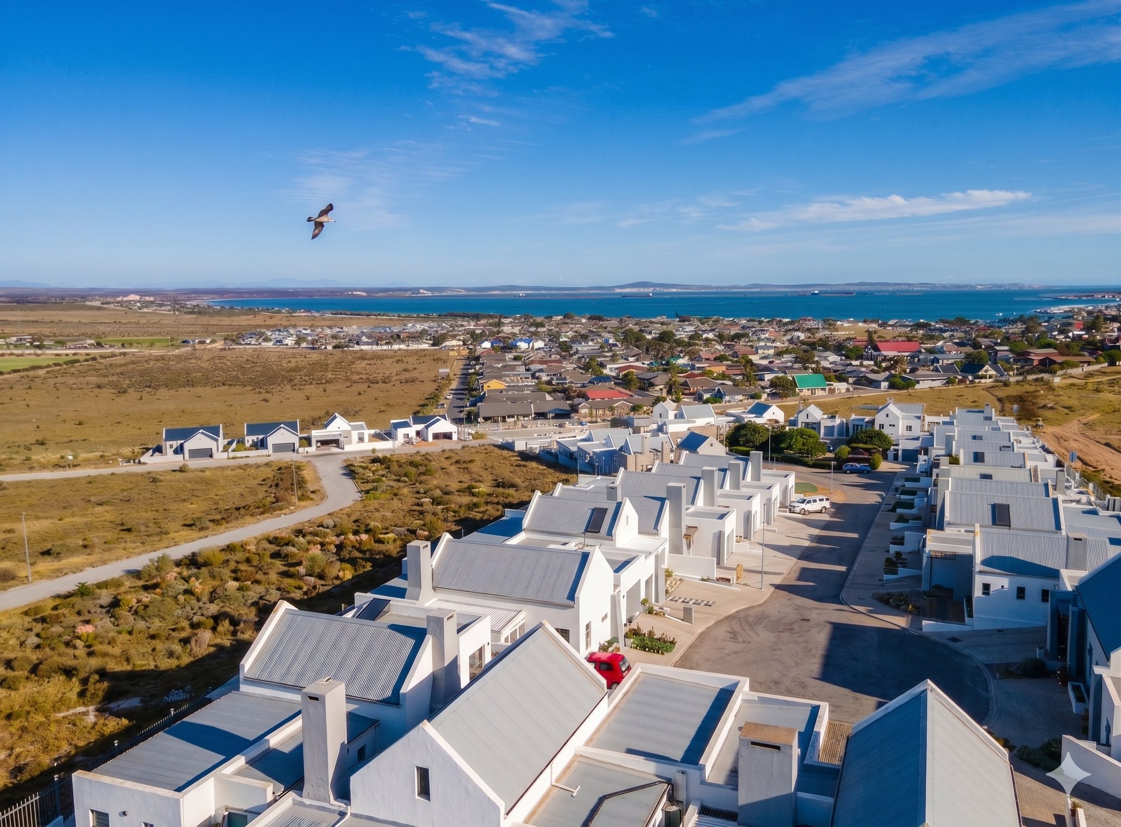 Aerial view of Welgedaan Estate with Saldanha Bay in the background