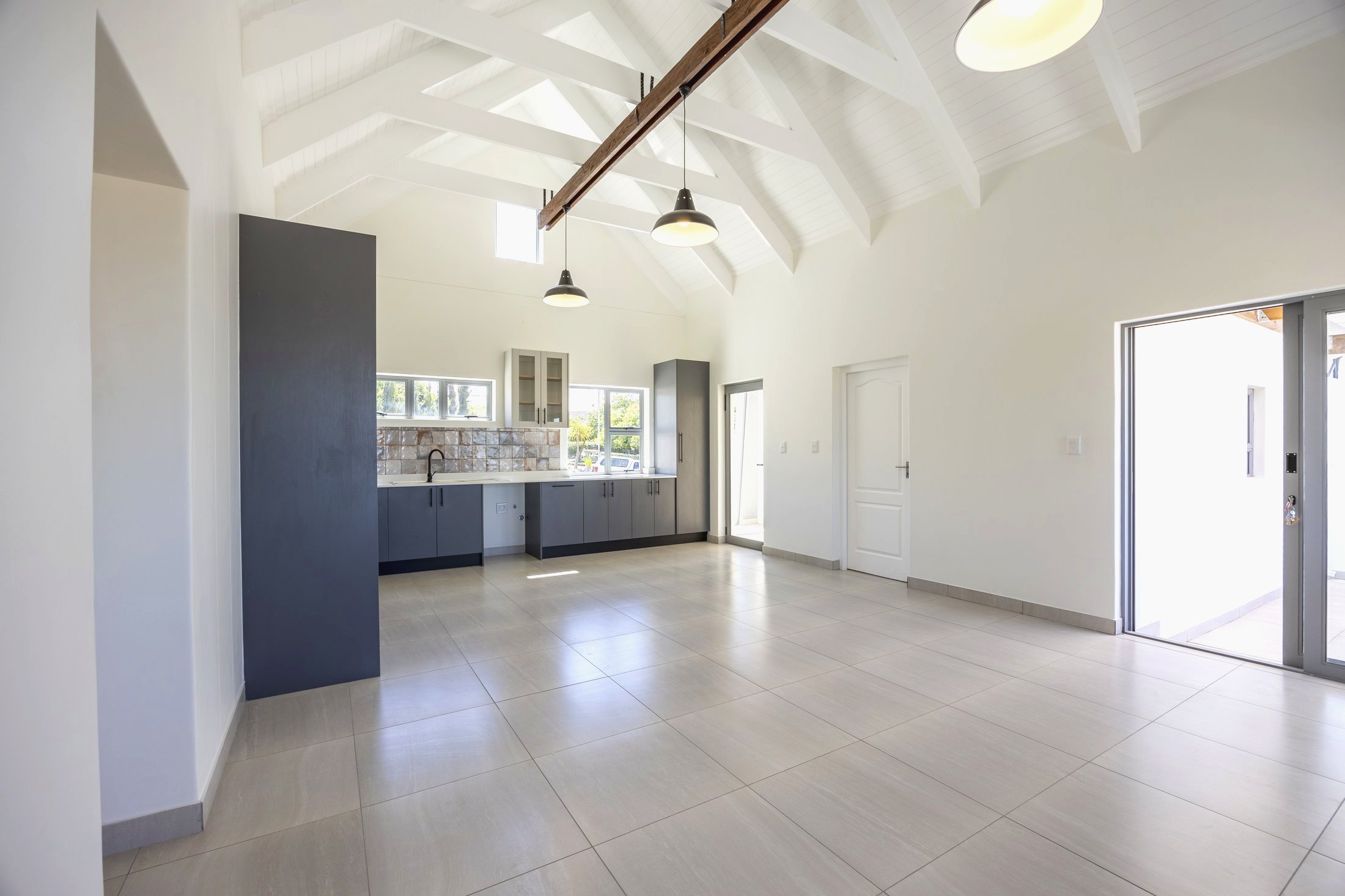 Open-plan kitchen, dining and living with vaulted ceiling